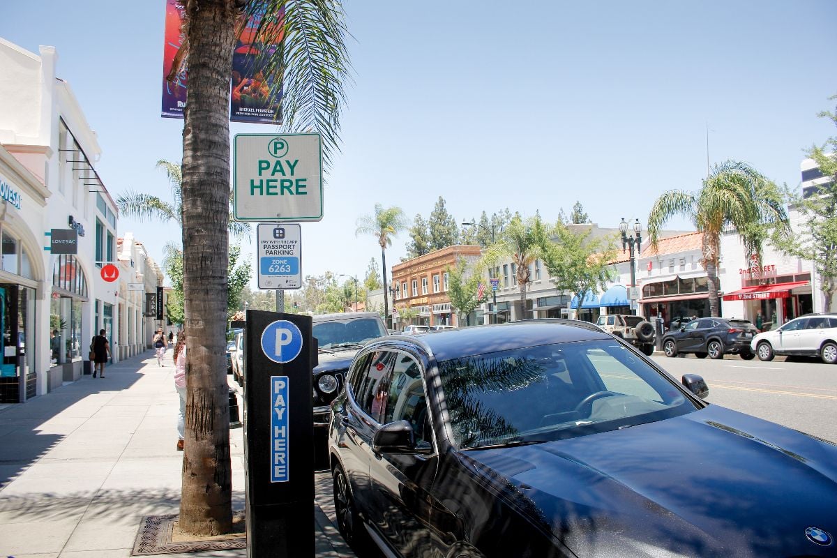 A view of a parking pay meter kiosk next to the street.