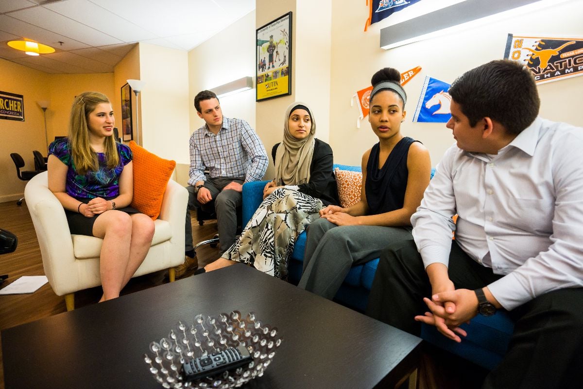 Diverse students having a conversation in a student lounge.