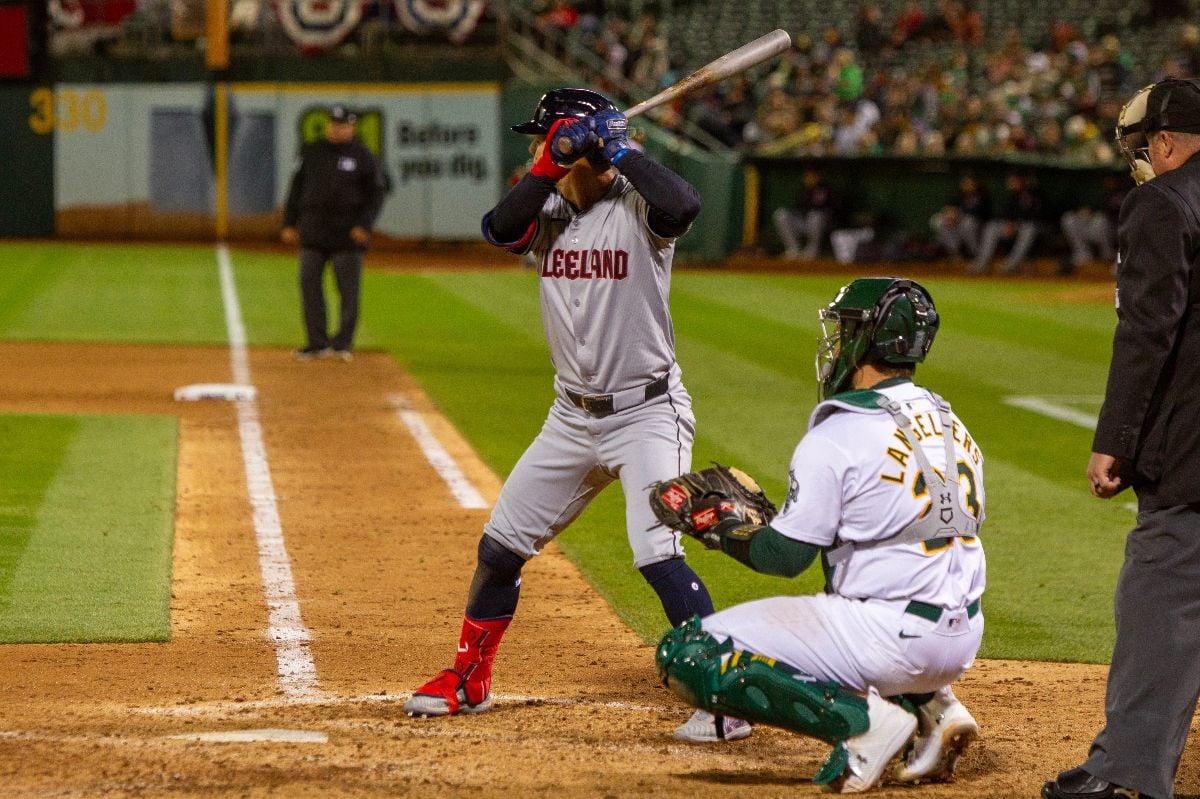Cleveland Guardians infielder Andrew Gimenez bats against the Oakland Athletics on Opening Day at the Oakland Coliseum.