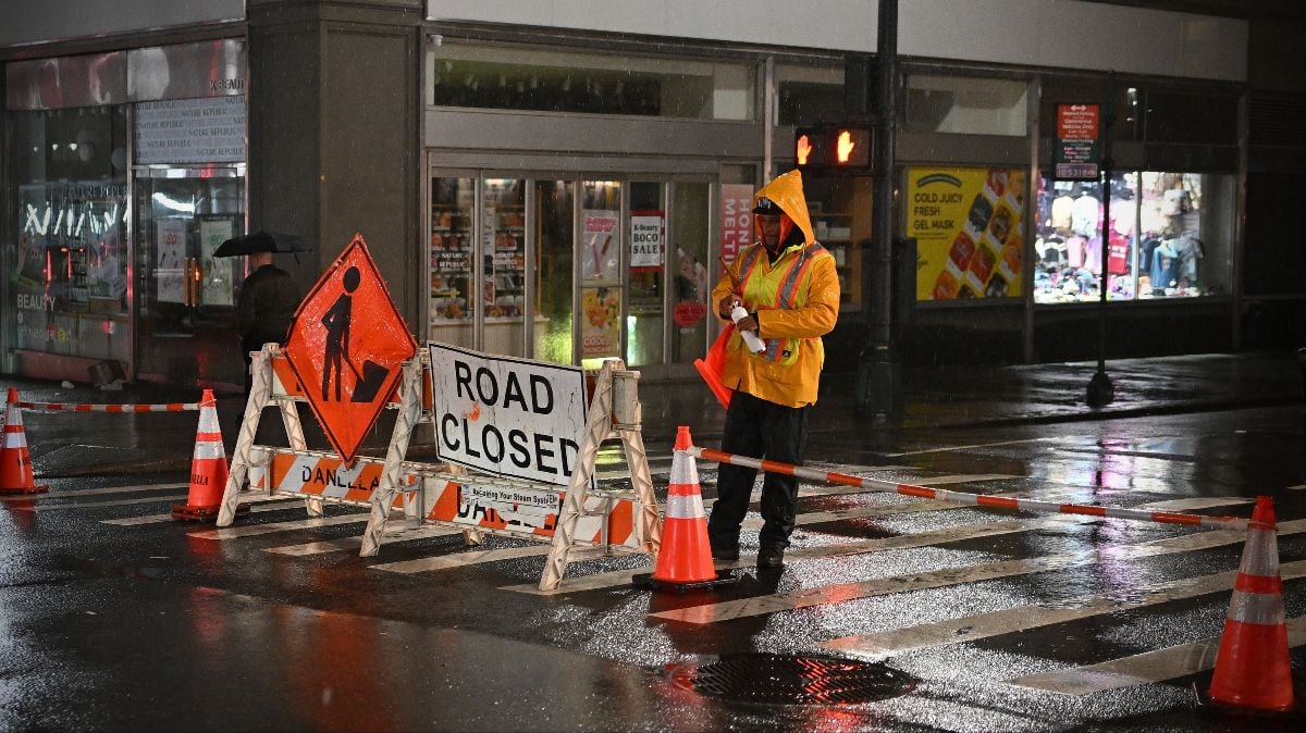 Highway maintenance close a road to repair a surface at a road works on a midtown Manhattan street on a rainy night on November 21, 2024 in New York City, USA.