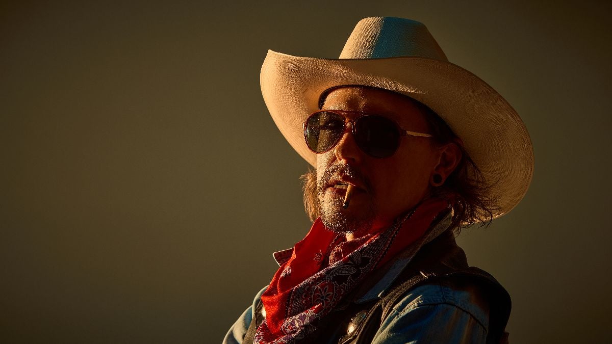 Cowboy in red bandana, sunglasses, cowboy hat and leather jacket.
