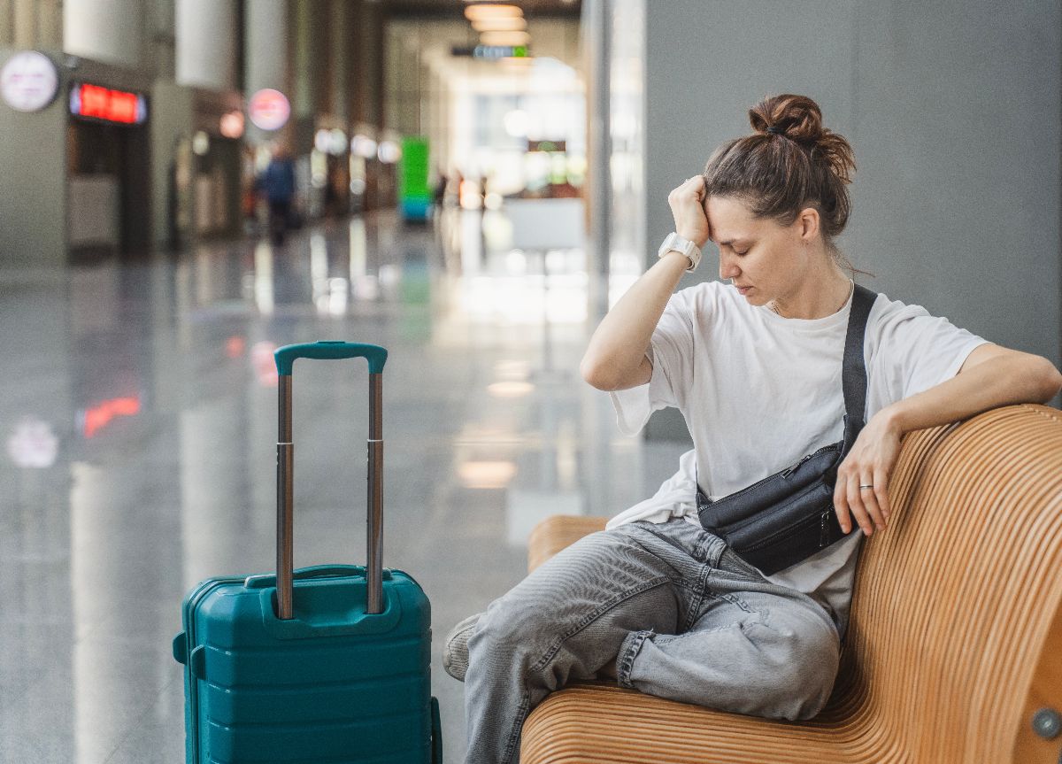 Traveler waiting for flight or train departure at train station.