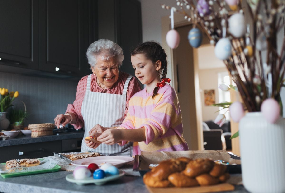 Grandmother with grandaughter preparing traditional Easter meals.