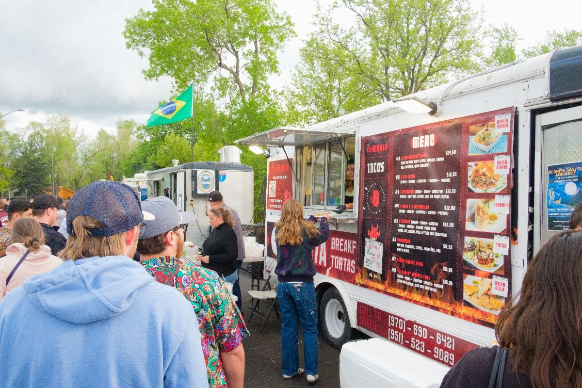 Crowds gather around food trucks.