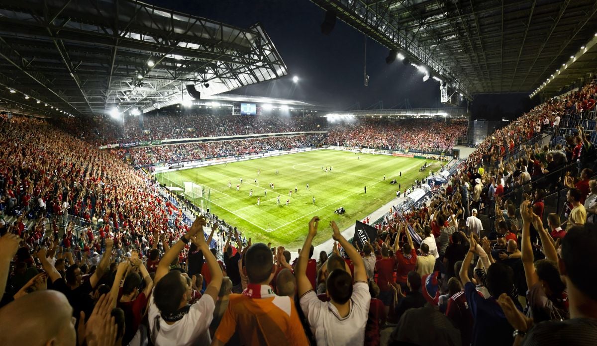 People cheering during football game night.