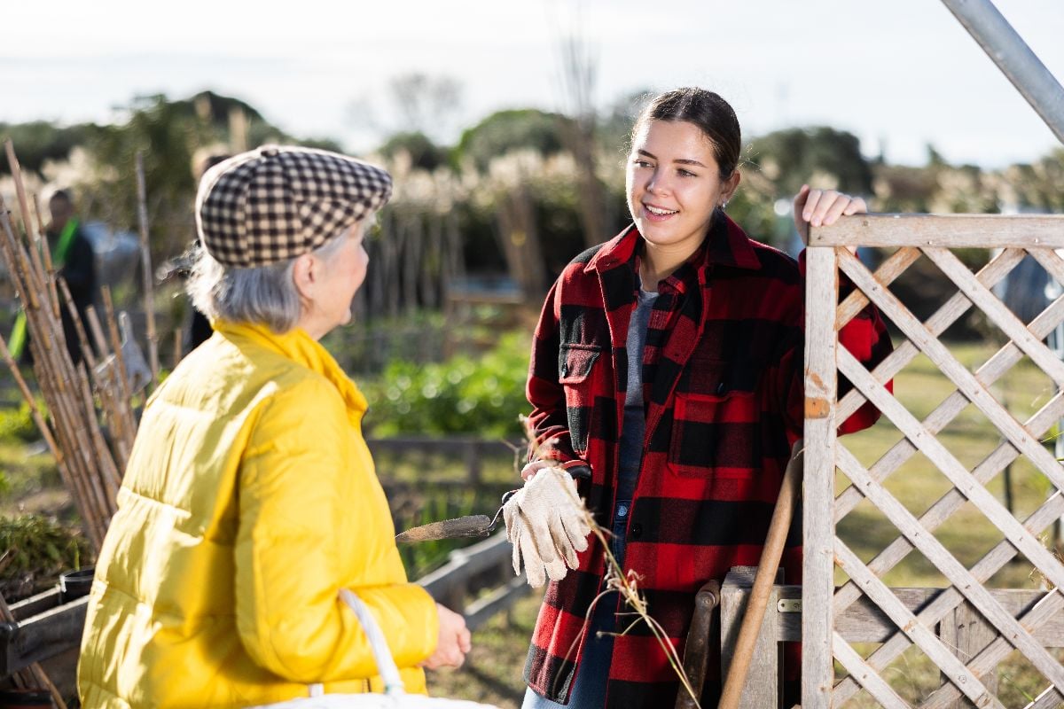 Young and senior woman discussing gardening.