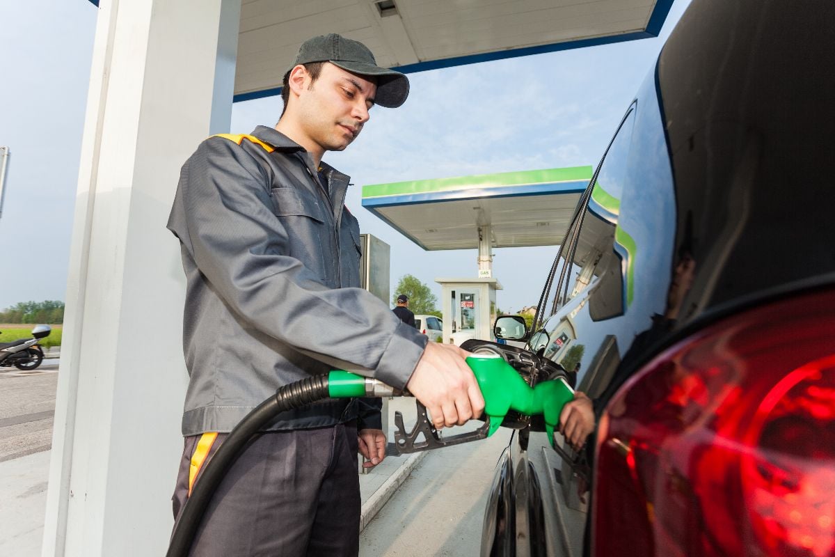 Gas station assistant refueling a car.