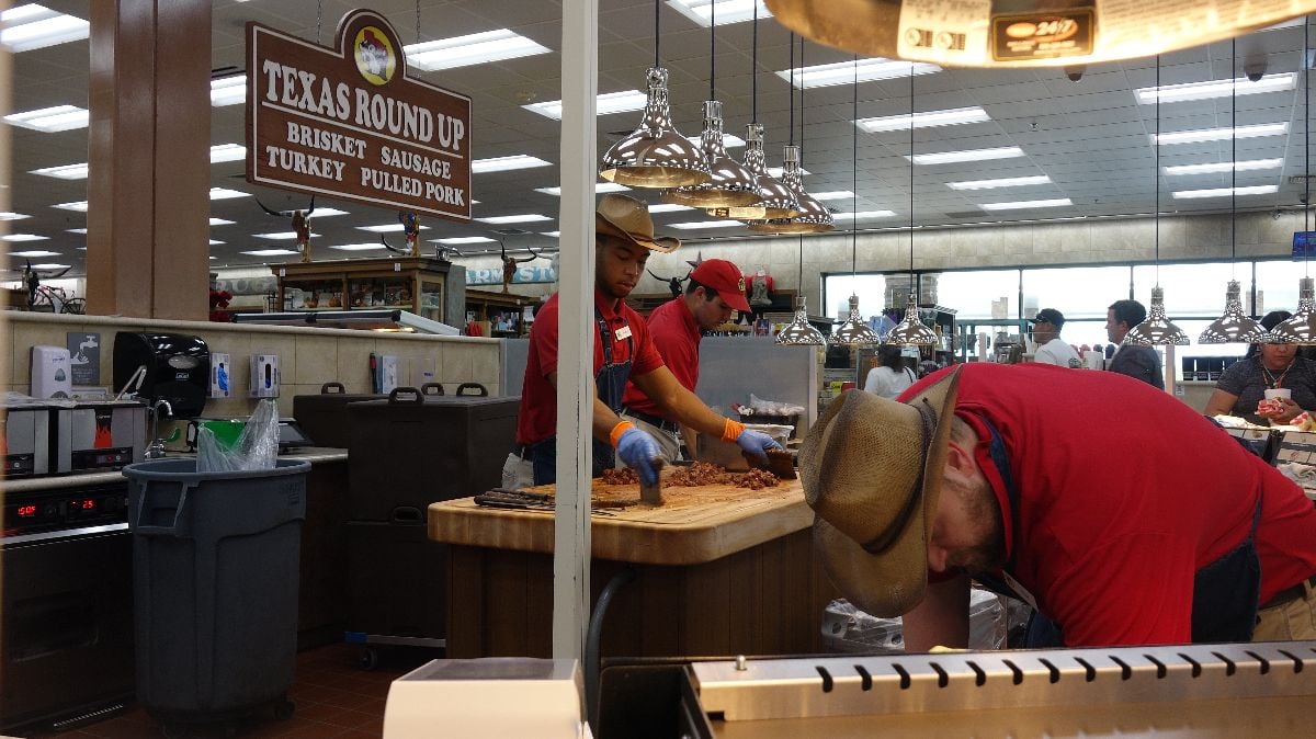 Buc-ee's employees in Texas store carving barbecue.