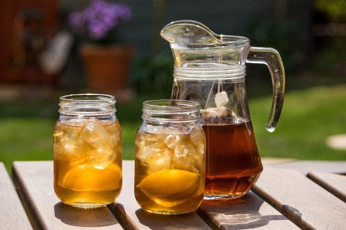 Sweet iced tea in pitcher and jars.