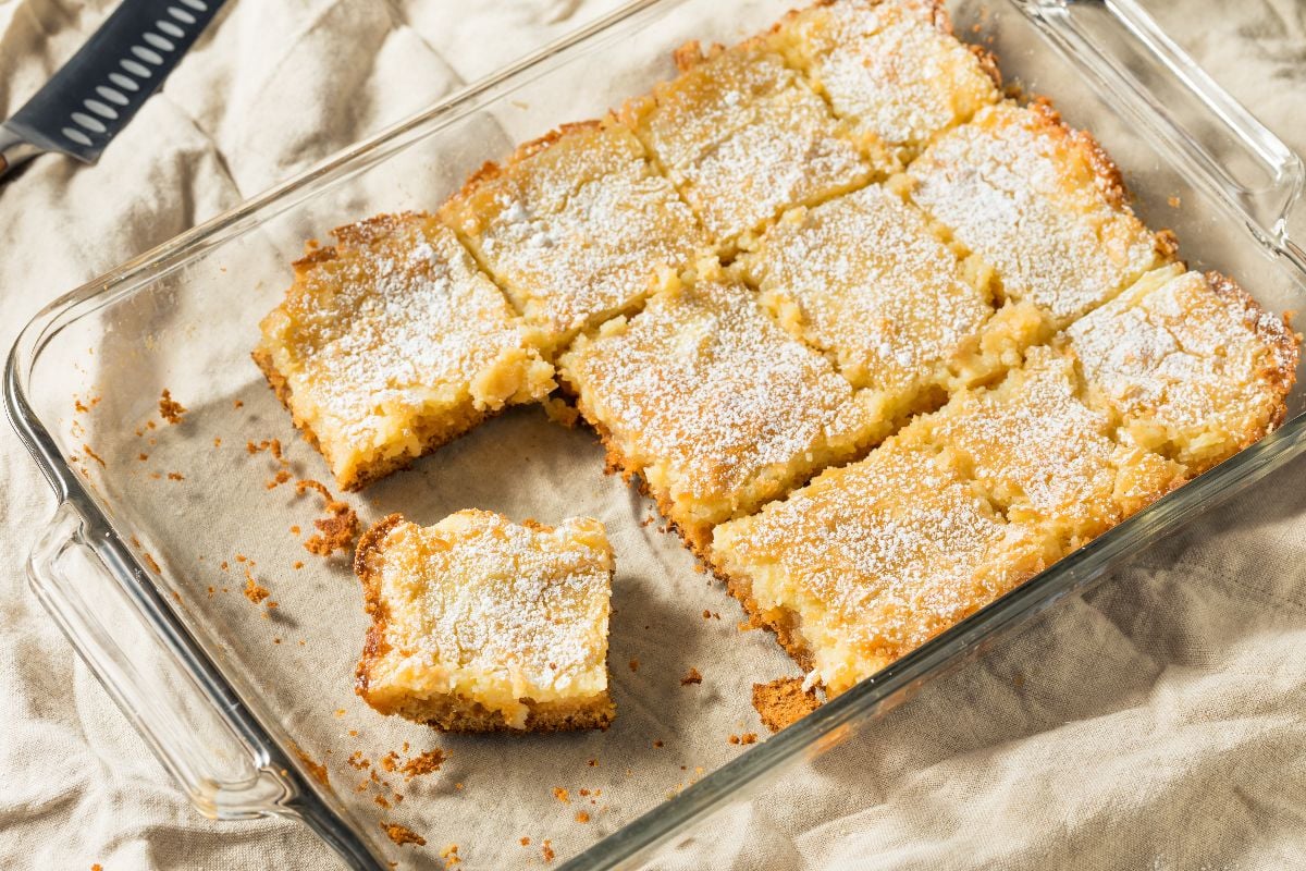 Homemade gooey butter cake with powdered sugar.