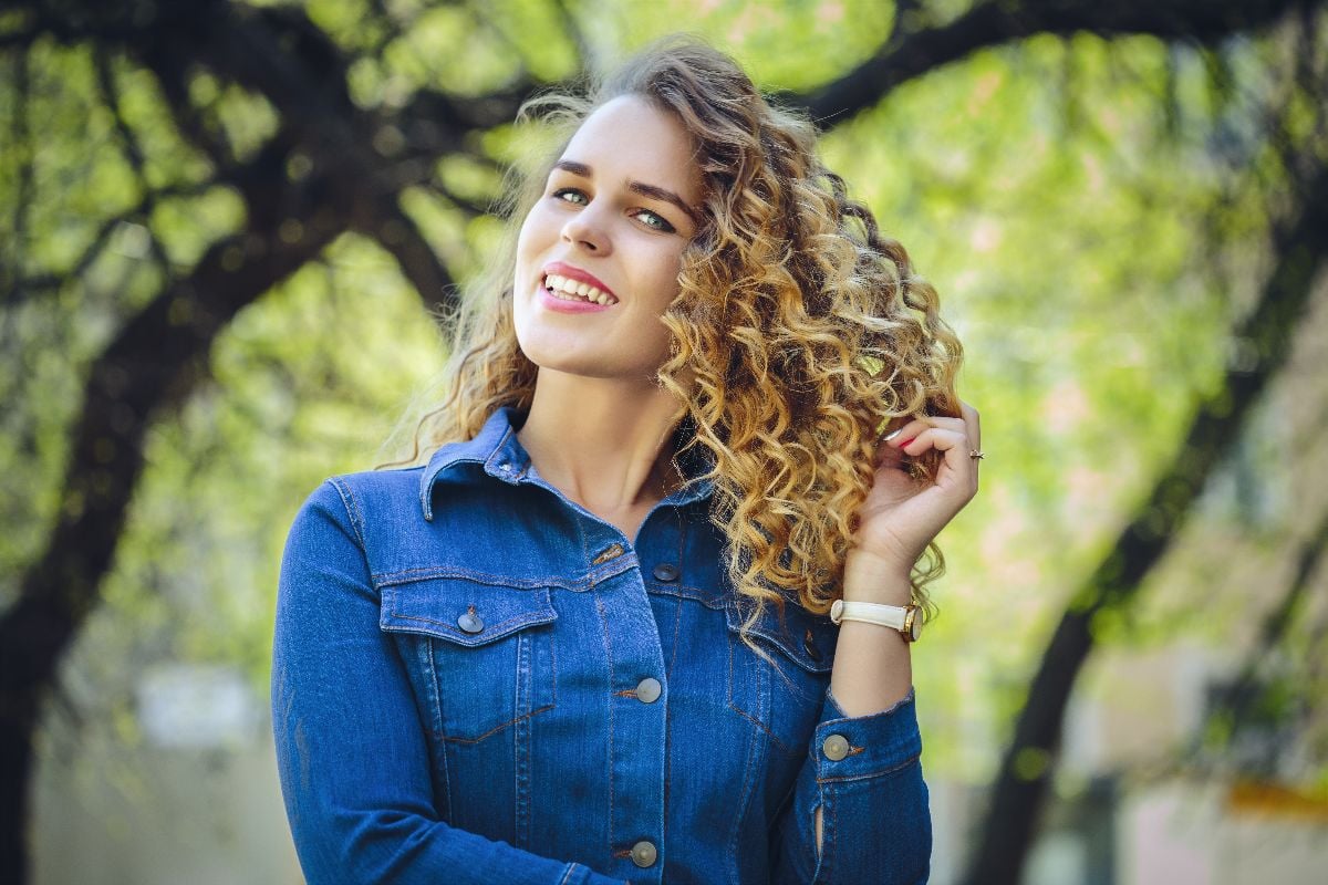 Woman in curls outdoors.