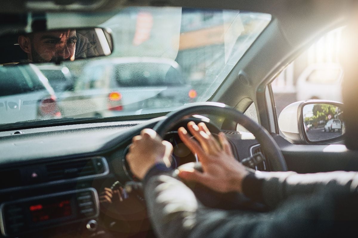 Man in car tapping the horn.