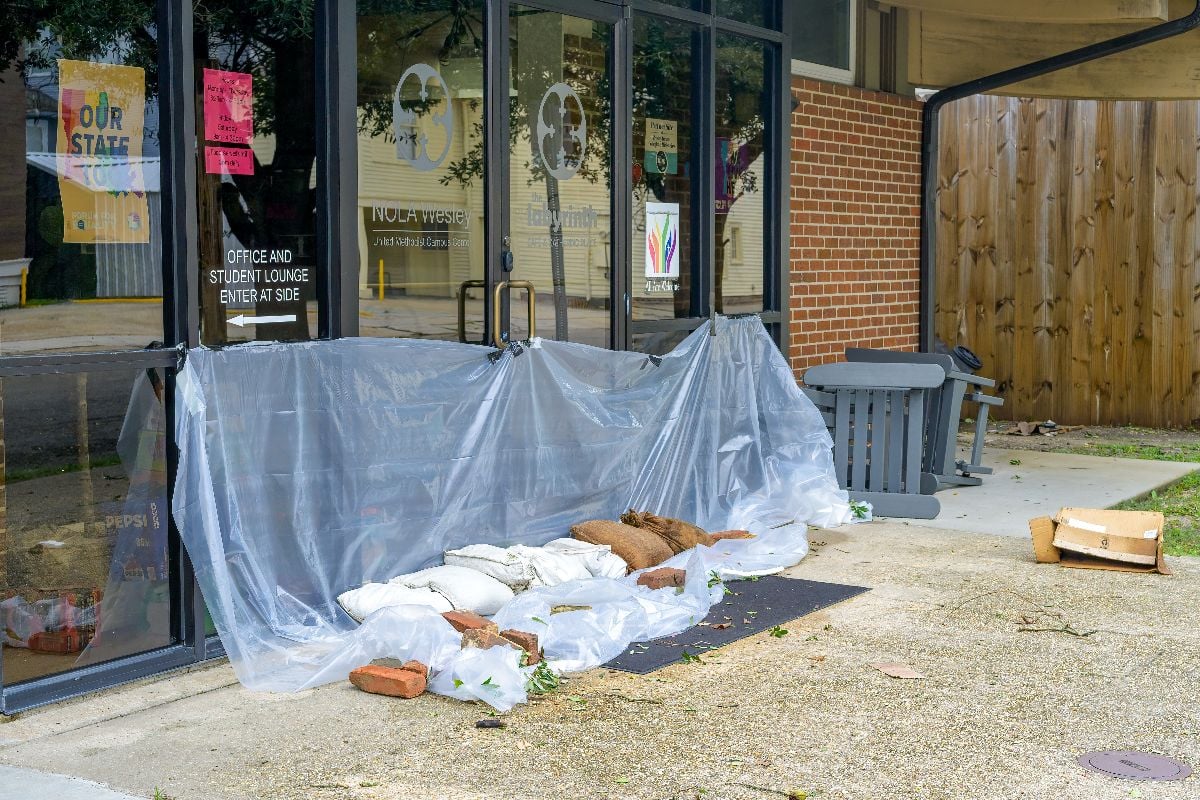 Plastic and sandbags placed in front of entrance to NOLA Wesley United Methodist Campus Center.
