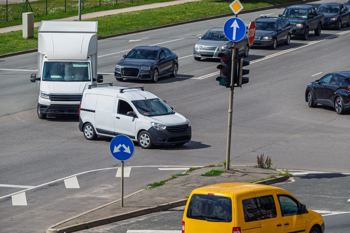 View of an intersection during heavy traffic, where cars are making a left turn.