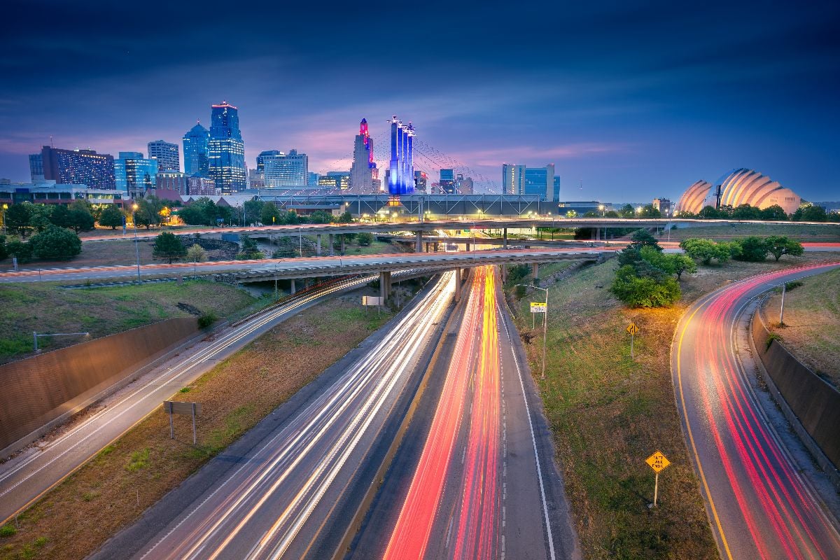 Cityscape image of Kansas City skyline with busy highway.