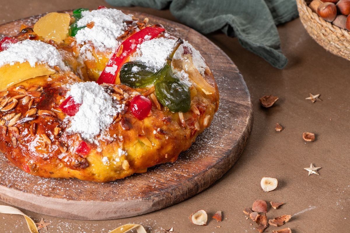 Bolo Rei or Kings Cake on a wooden chopping board.