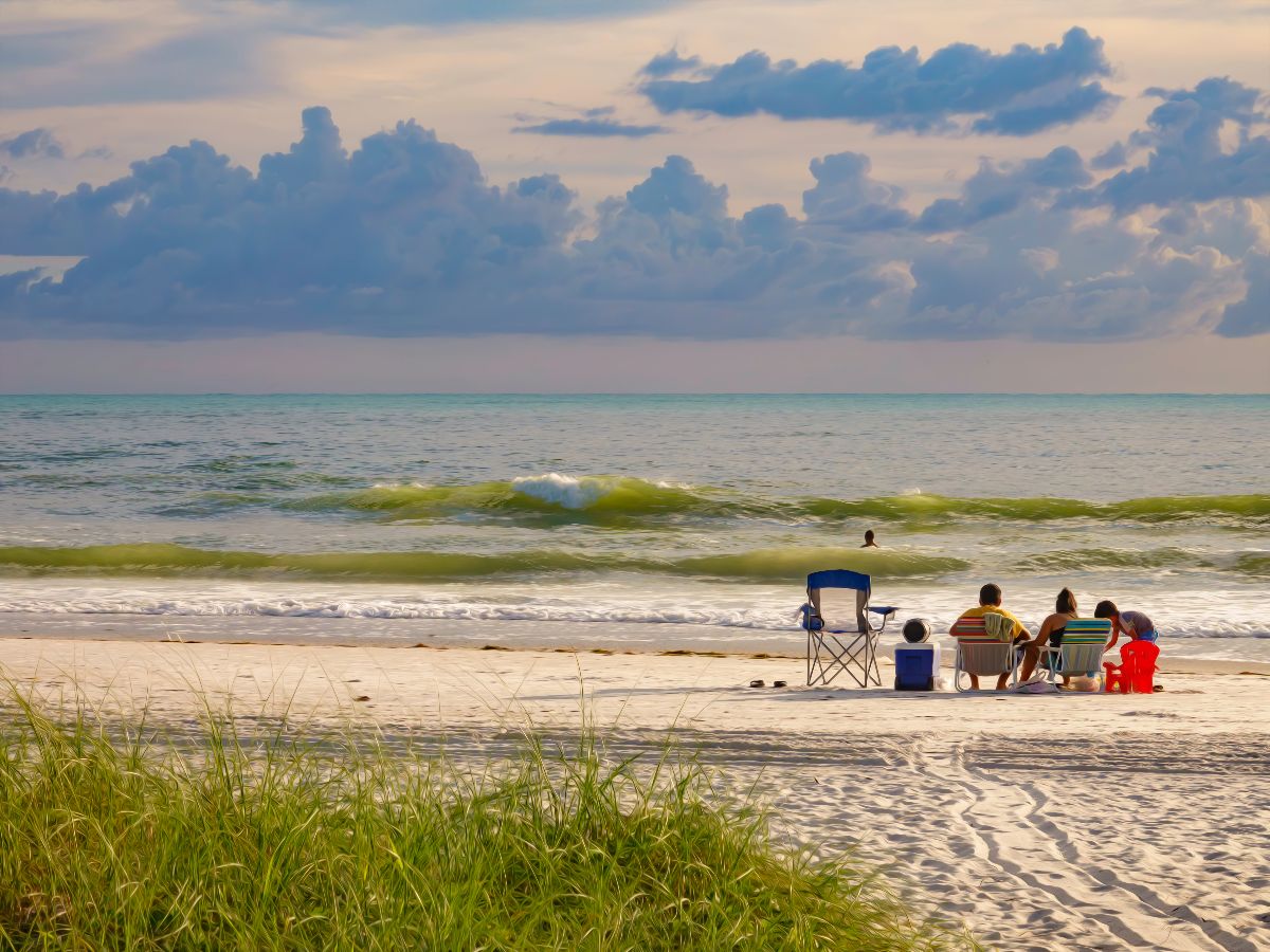 Young family on sandy beach.