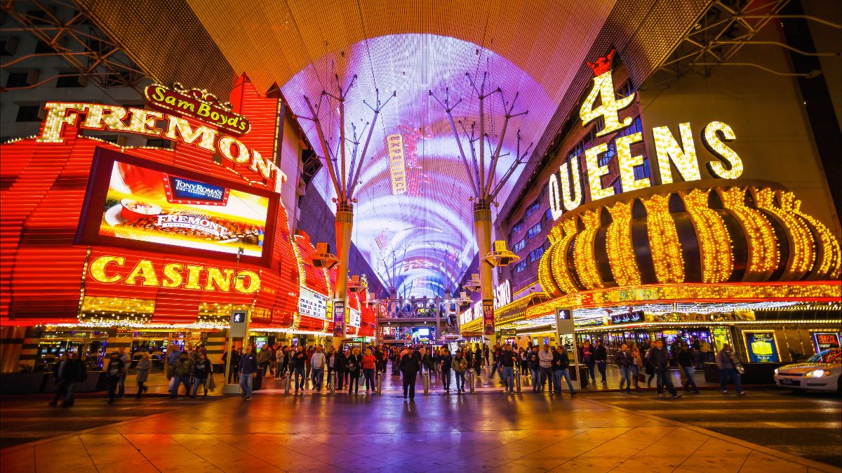 Bright neon lights and tourists at the Fremont Street Experience in Las Vegas, Nevada.