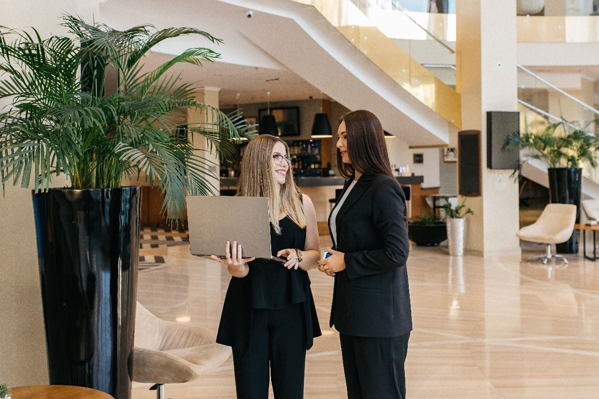 Business women discussing a business plan in the office lobby.