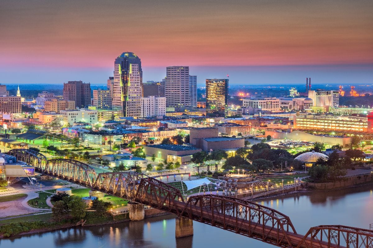 Shreveport, Louisiana skyline over the Red River at dusk.