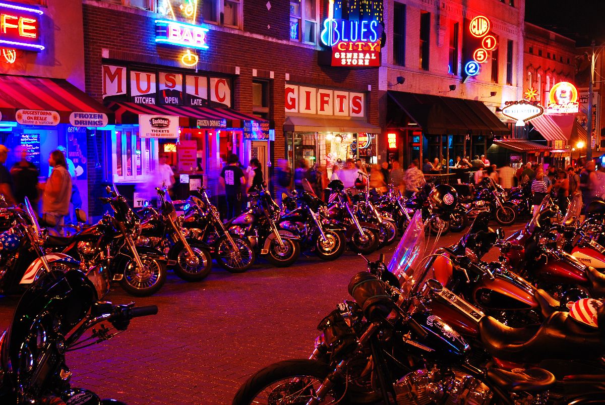 Motorcycles crowd in front of the taverns and cafes.