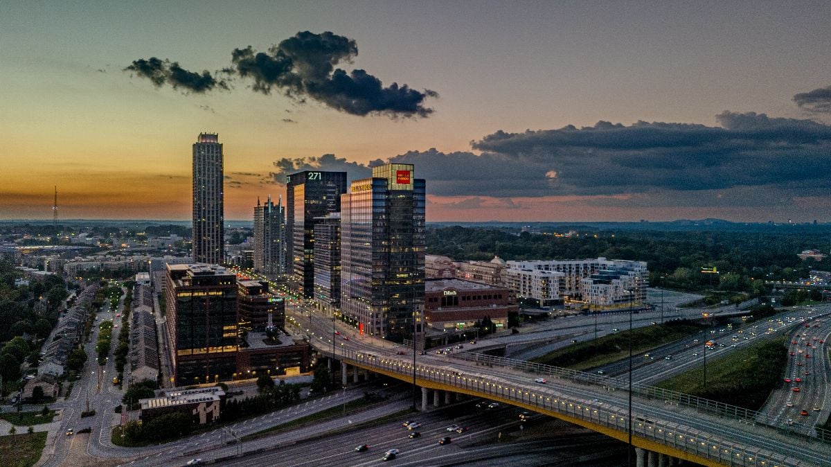 Aerial panoramic view of midtown skyline capturing sunset.