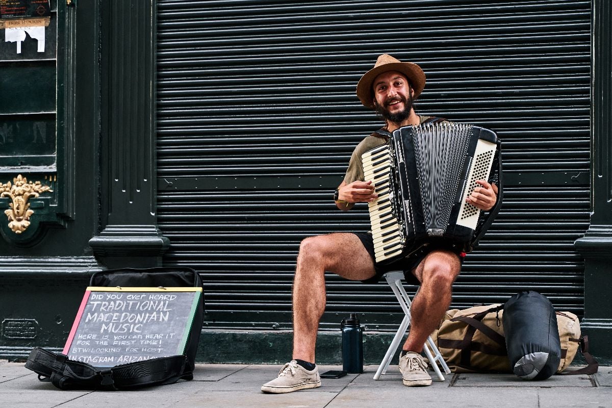 Musician playing accordion in a street.