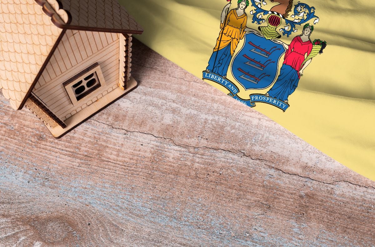House model near New Jersey flag.