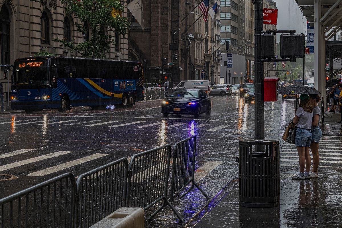 A ground shot looking north, up a wet Fifth Avenue on a rainy day.