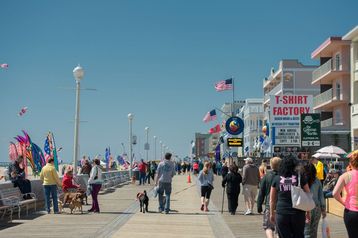 People walking the boardwalk in Maryland Ocean City.