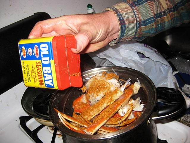 Putting Old Bay on crab legs.