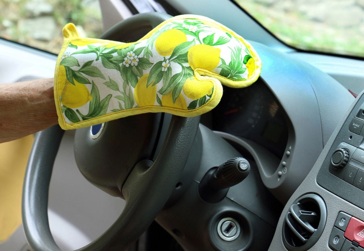 Man driving with oven glove.