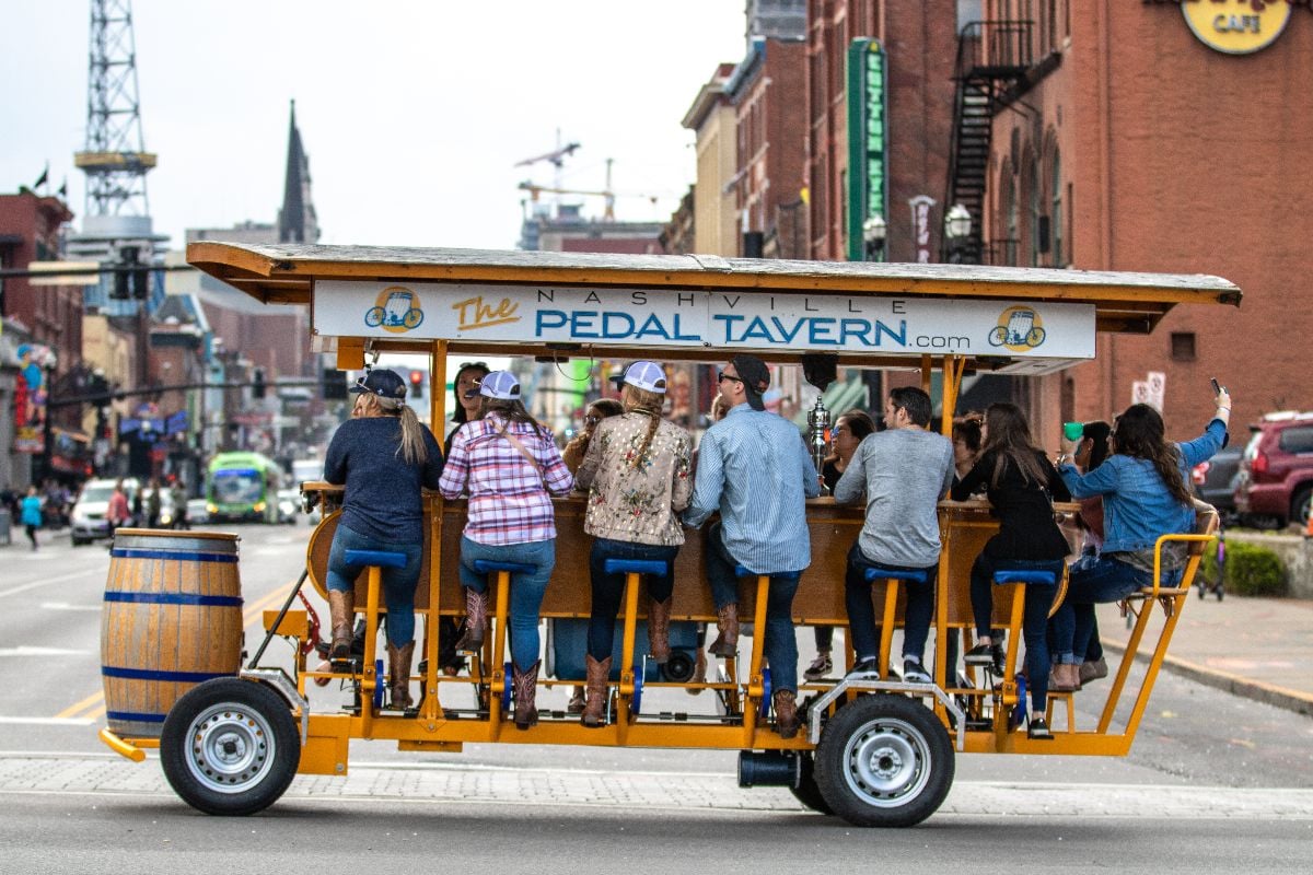 A Pedal Tavern party bike on a sunny day crossing Broadway.