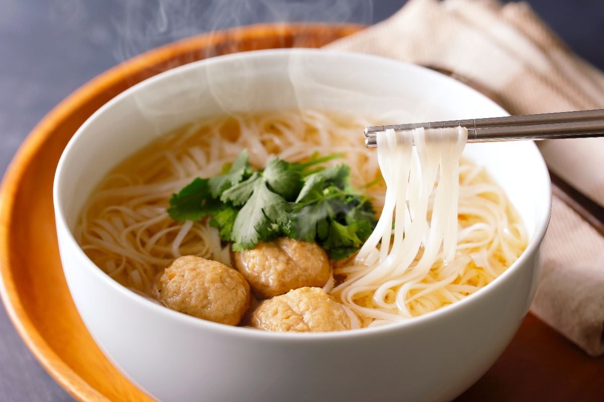 Pho noodles in chopsticks.