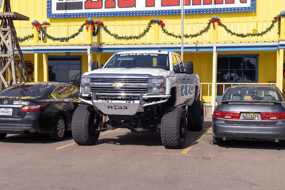 White Chevrolet Silverado on a parking lot.