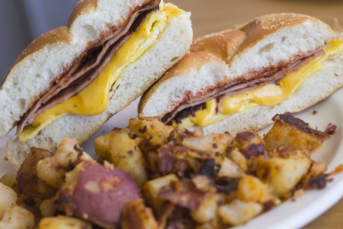 Taylor ham, pork roll, egg and cheese breakfast sandwich on a kaiser roll.