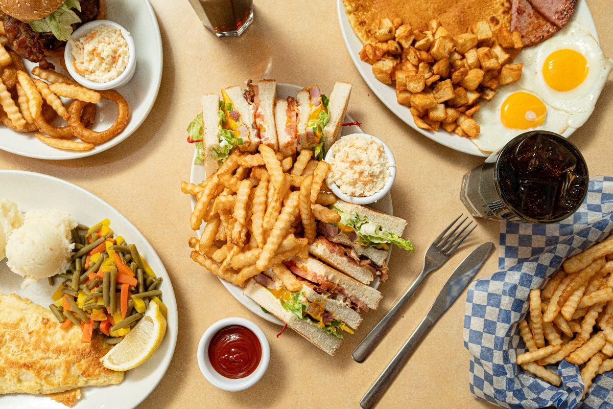 Vegetable sandwich and loaded fries, ketchup, white sauce, and mayonnaise.