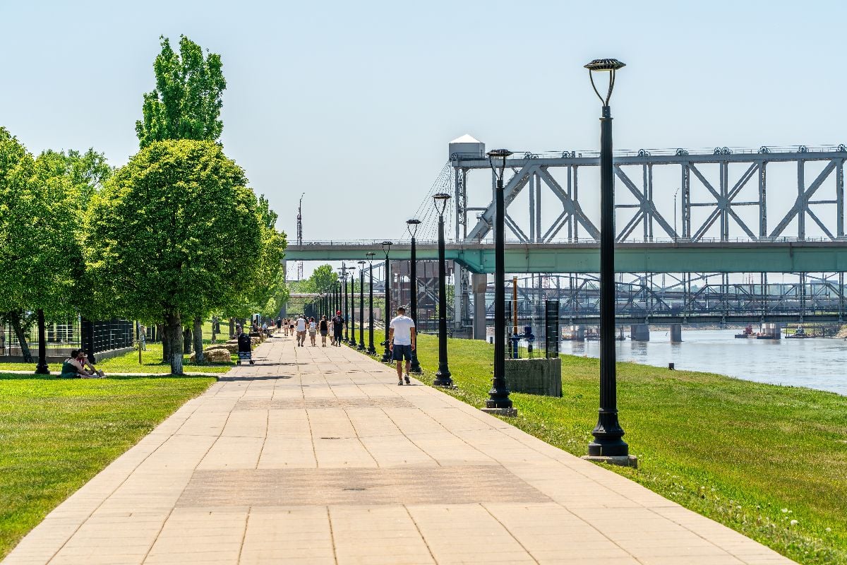 Pedestrians walking along Berkely Riverfront Park along the Missouri River.