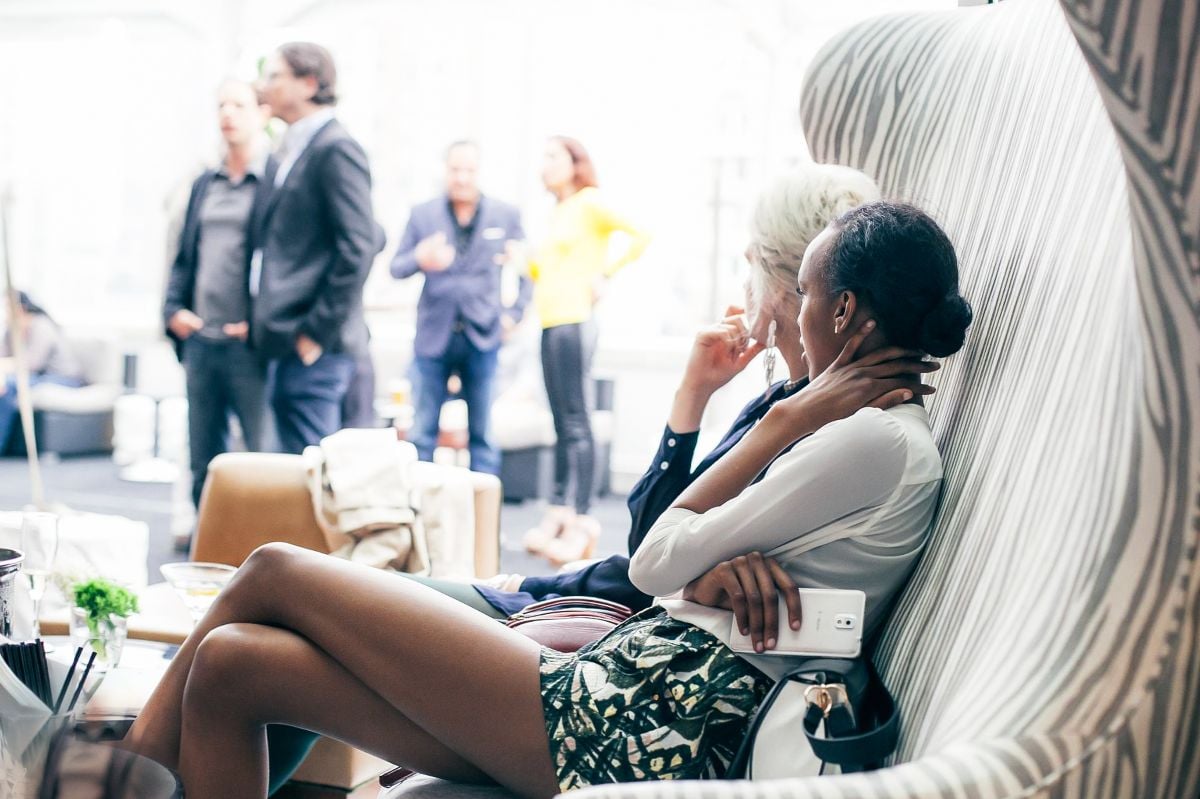 View of models seating at the roof top party.