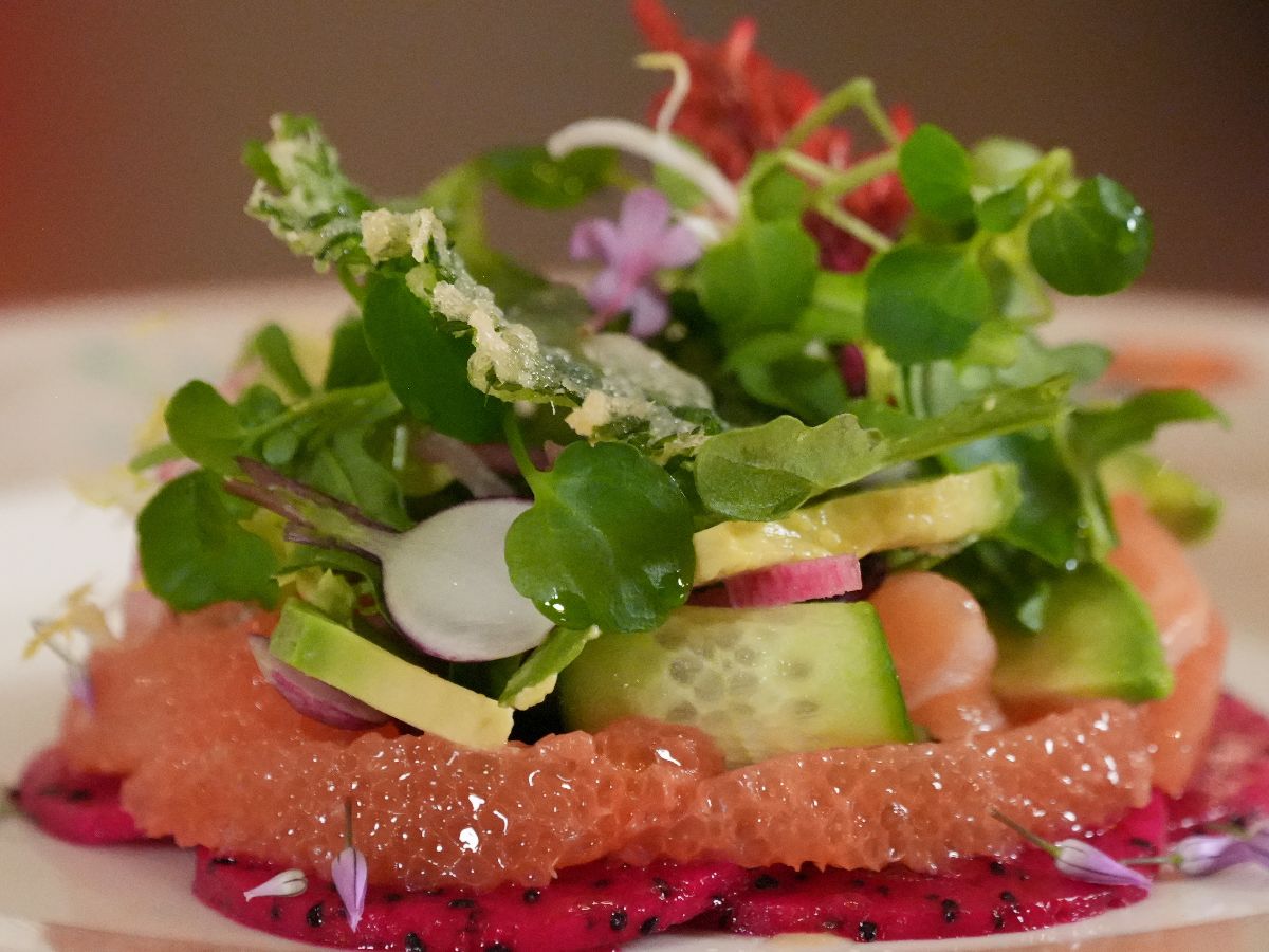 Salad with arranged with fruits on the bottom.