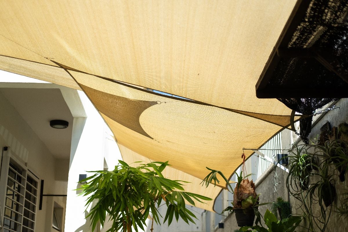 Sunshade sails providing a cozy, shaded outdoor space surrounded by greenery.
