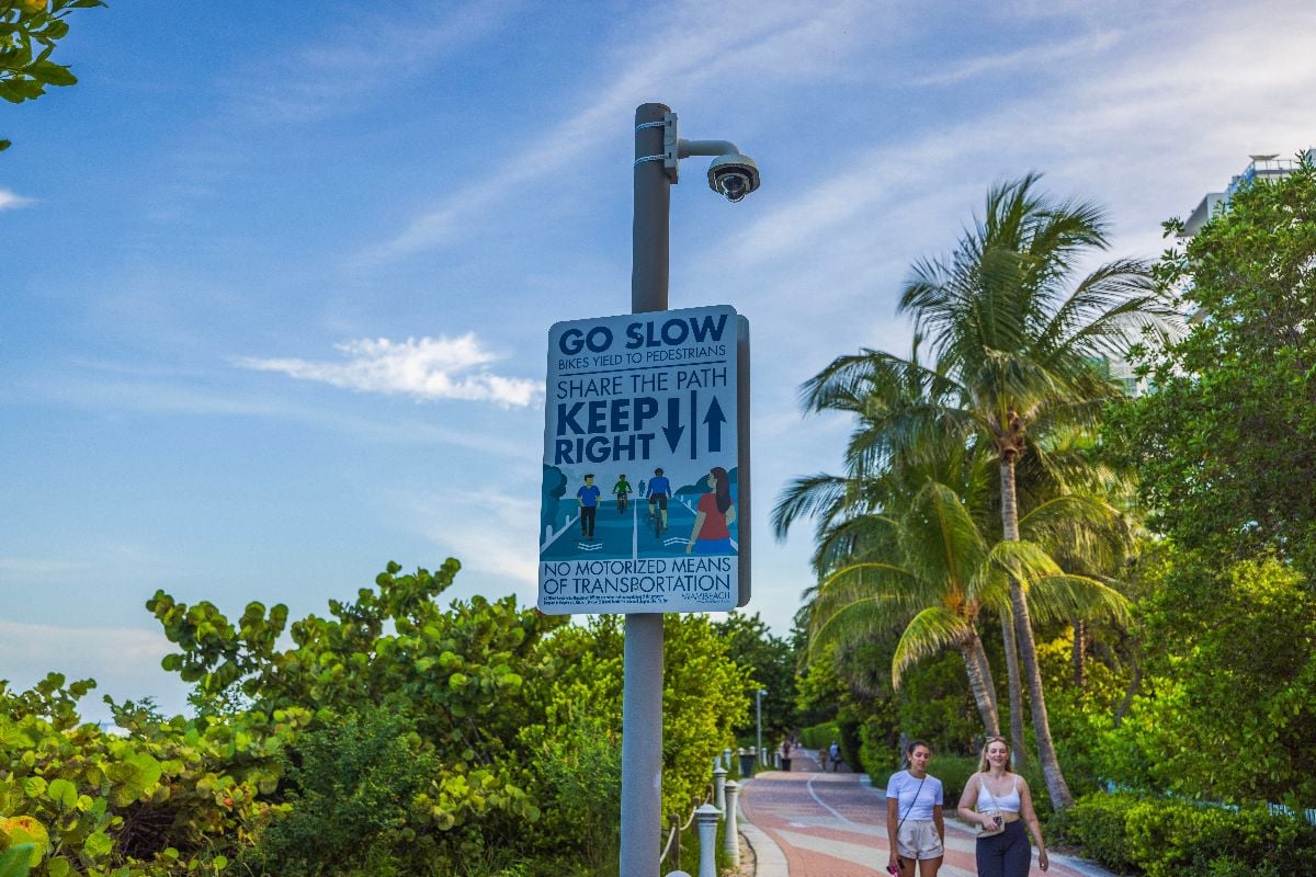 Close up view of adaptive poster on pole urging proper walking etiquette.
