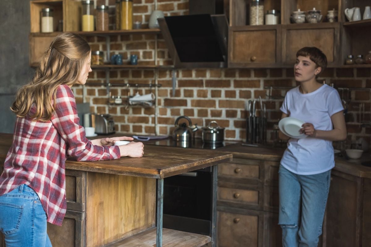 Women talking on kitchen in morning.