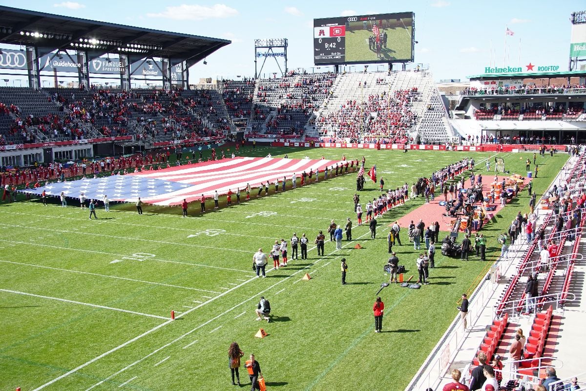 A flag is waved during the national anthem before a United Football League game in the Washington DC.