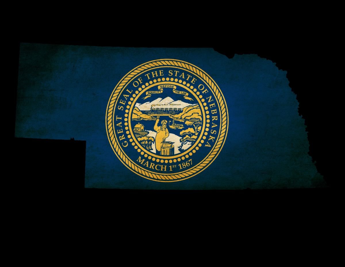 Nebraska state map outline with grunge effect flag.