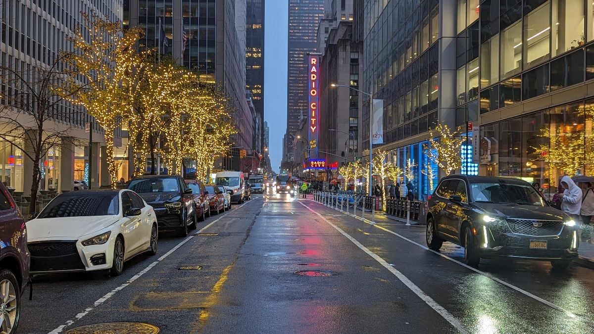 Streetscape view of West 50th Street on a rainy night.