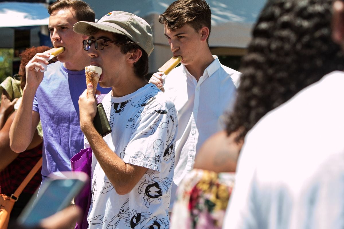 Young men eating ice cream at the Atlanta Ice Cream Festival.