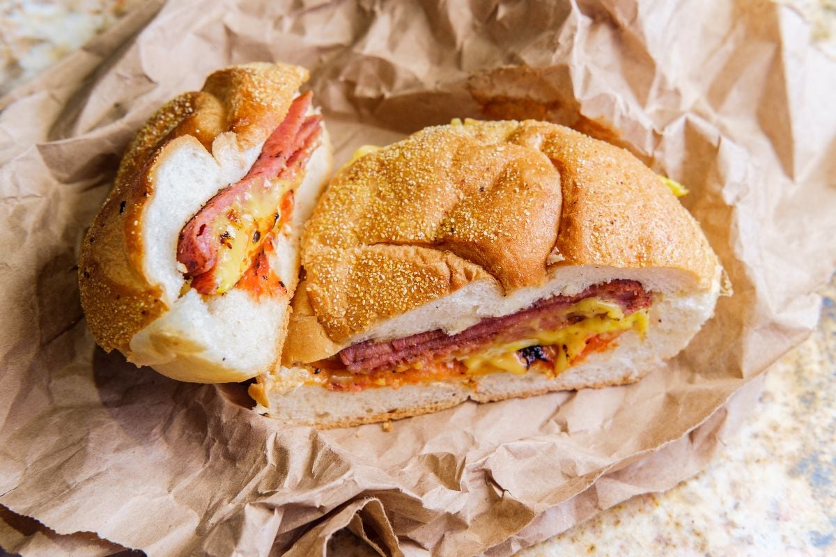 Taylor ham, pork roll, egg and cheese breakfast sandwich on a kaiser roll.