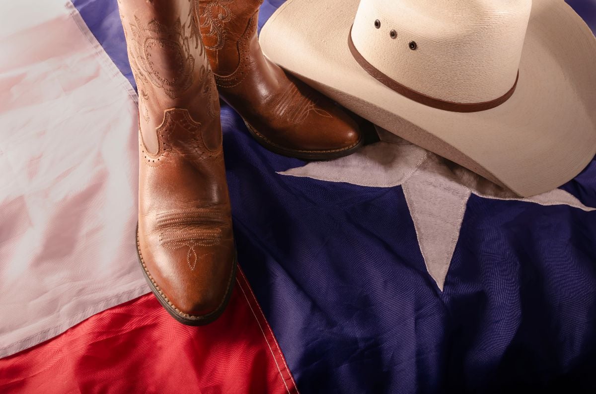 Cowboy boots and hat on Texas flag.