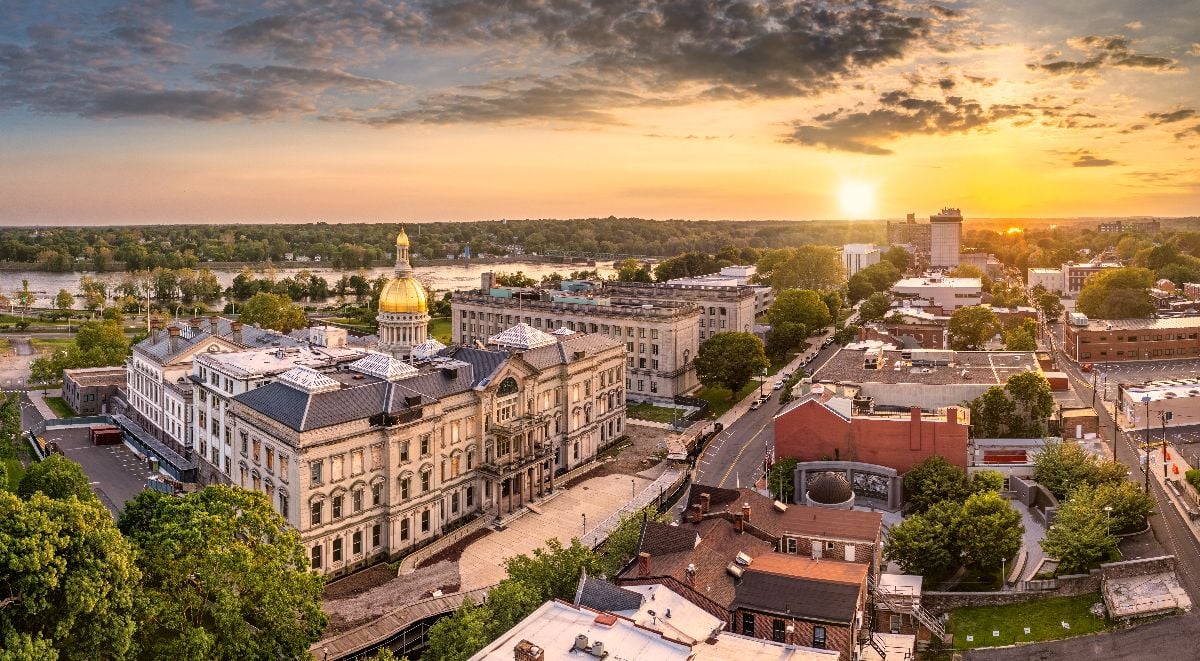 Aerial panorama of Trenton New Jersey skyline and state capitol at sunset.